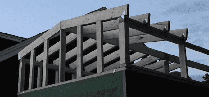 The roof beams sit on top of the loft frame to maximize loft head room